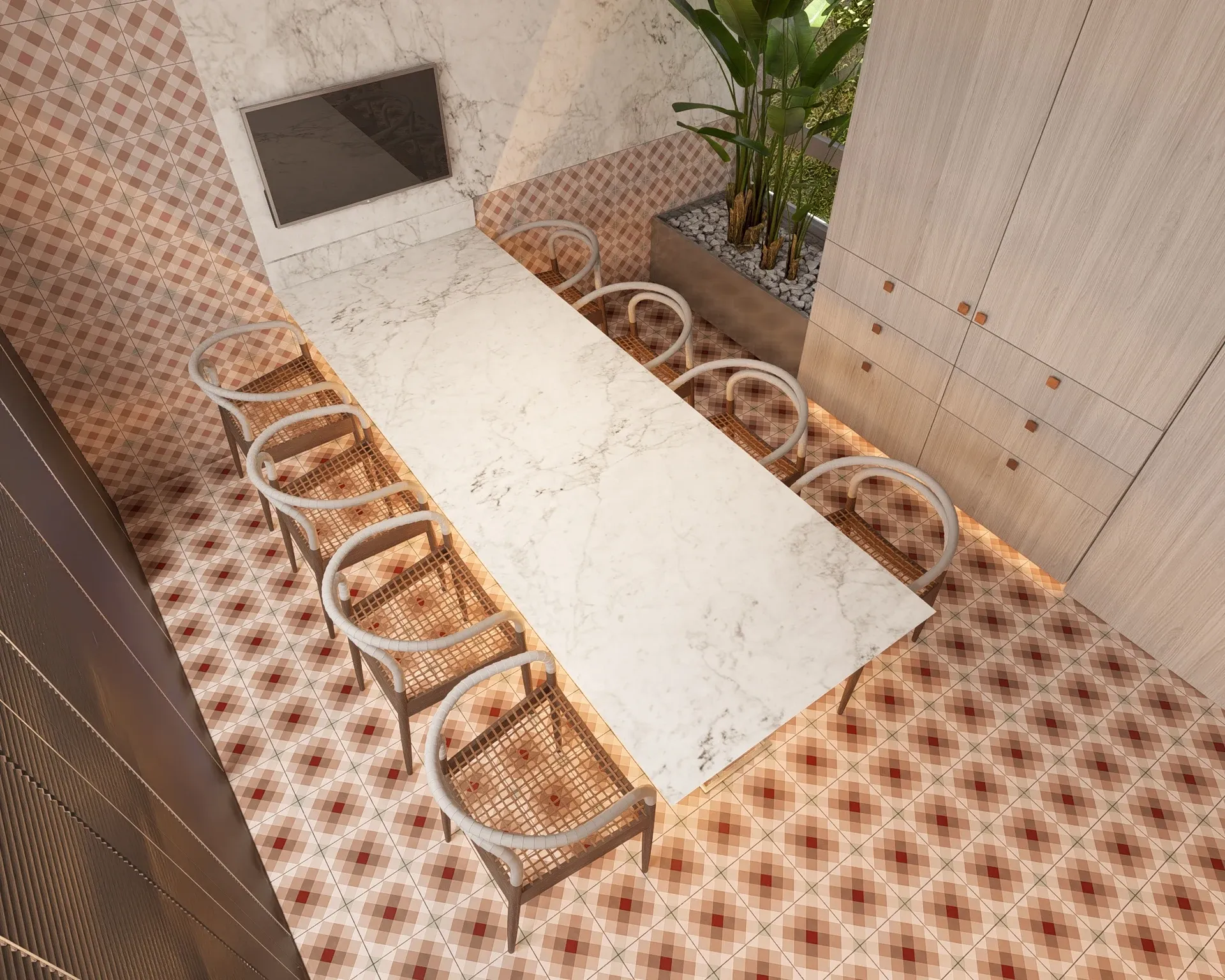 Vista aérea da sala de jantar com mesa em mármore calacatta branco para 10 lugares com cadeiras em palhinha, piso gráfico em ladrilho hidráulico xadrez e jardineira tropical